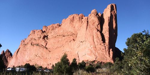 Panoramic view of rocks against clear blue sky