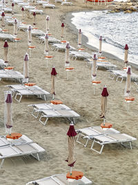 Preparation of the bathing season in liguria, beach with sand umbrellas and sunbeds