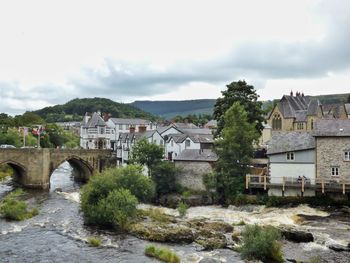 Dee river flowing by buildings at llangollen