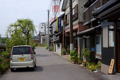 Street amidst buildings against sky in city