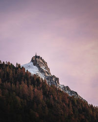 Low angle view of castle on mountain against sky during sunset