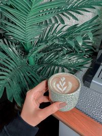 Midsection of woman holding coffee