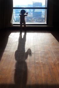 Shadow of man on hardwood floor at home