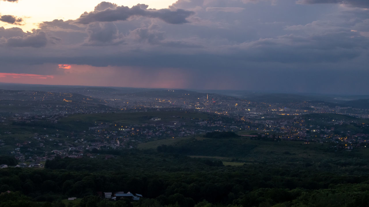 HIGH ANGLE SHOT OF TOWNSCAPE AGAINST SKY DURING SUNSET