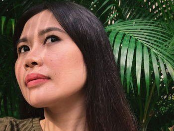 Close-up portrait of young woman looking away