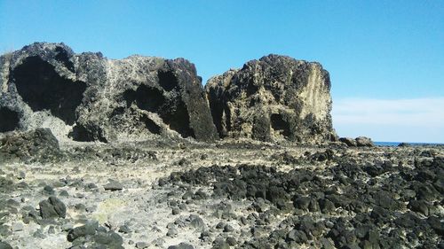 Rock formations against clear blue sky