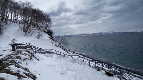 Scenic view of frozen lake against sky during winter