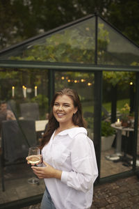 Smiling woman standing in garden