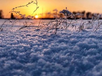 Scenic view of snow field against sky during sunset