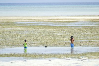 Full length of woman standing on beach