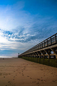 Scenic view of beach against blue sky