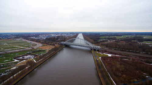 High angle view of bridge over river in city against sky