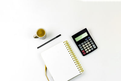 High angle view of books on table against white background
