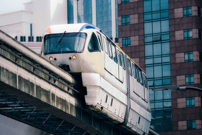 Low angle view of train on bridge in city