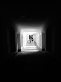 Rear view of woman walking in corridor