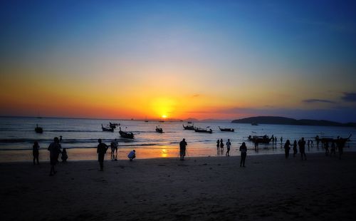 People on beach at sunset
