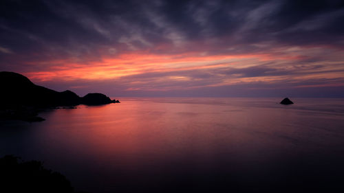 Scenic view of sea against orange sky