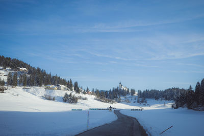 Scenic view of snow covered landscape against sky