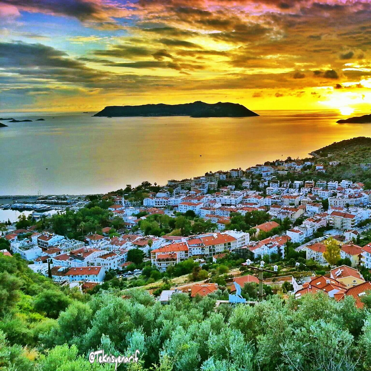 sunset, sea, water, sky, building exterior, architecture, built structure, high angle view, scenics, horizon over water, beauty in nature, orange color, tree, cloud - sky, town, tranquil scene, house, nature, residential district, townscape