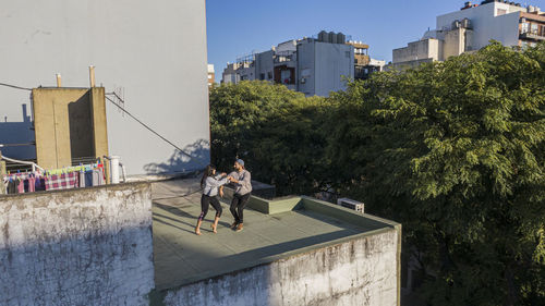 People on street amidst buildings in city