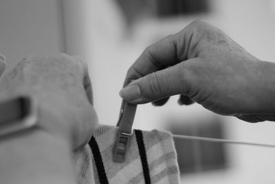 Cropped image of man holding clothespin