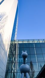 Low angle view of modern building against clear blue sky