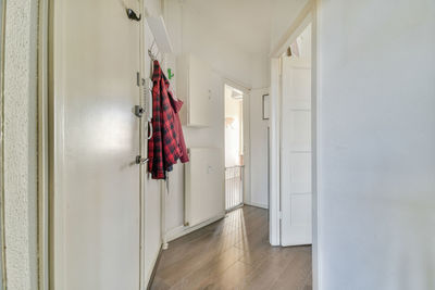 Rear view of woman standing in corridor