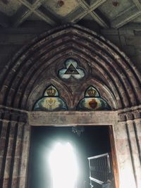 Low angle view of stained glass window in historic building