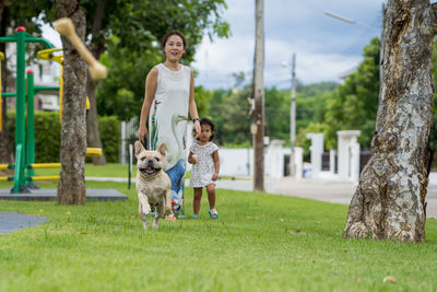 Mother and daughter with dog at park