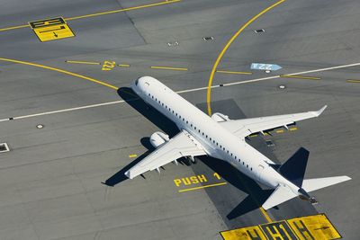 High angle view of airplane on airport runway