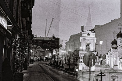 Street amidst buildings against sky