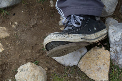 Low section of boy wearing shoes