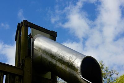 Low angle view of slide against sky