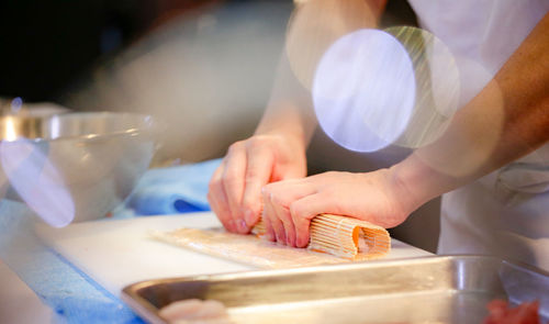 Midsection of man preparing food in kitchen