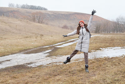 The young girl happy jump in mountains with exciting view. autumn mountain landscape.