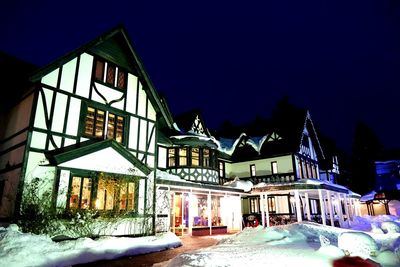 Houses against sky during winter at night