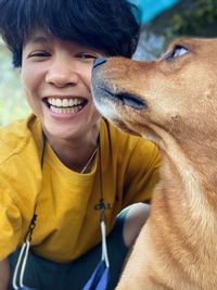 Portrait of a smiling young woman with dog