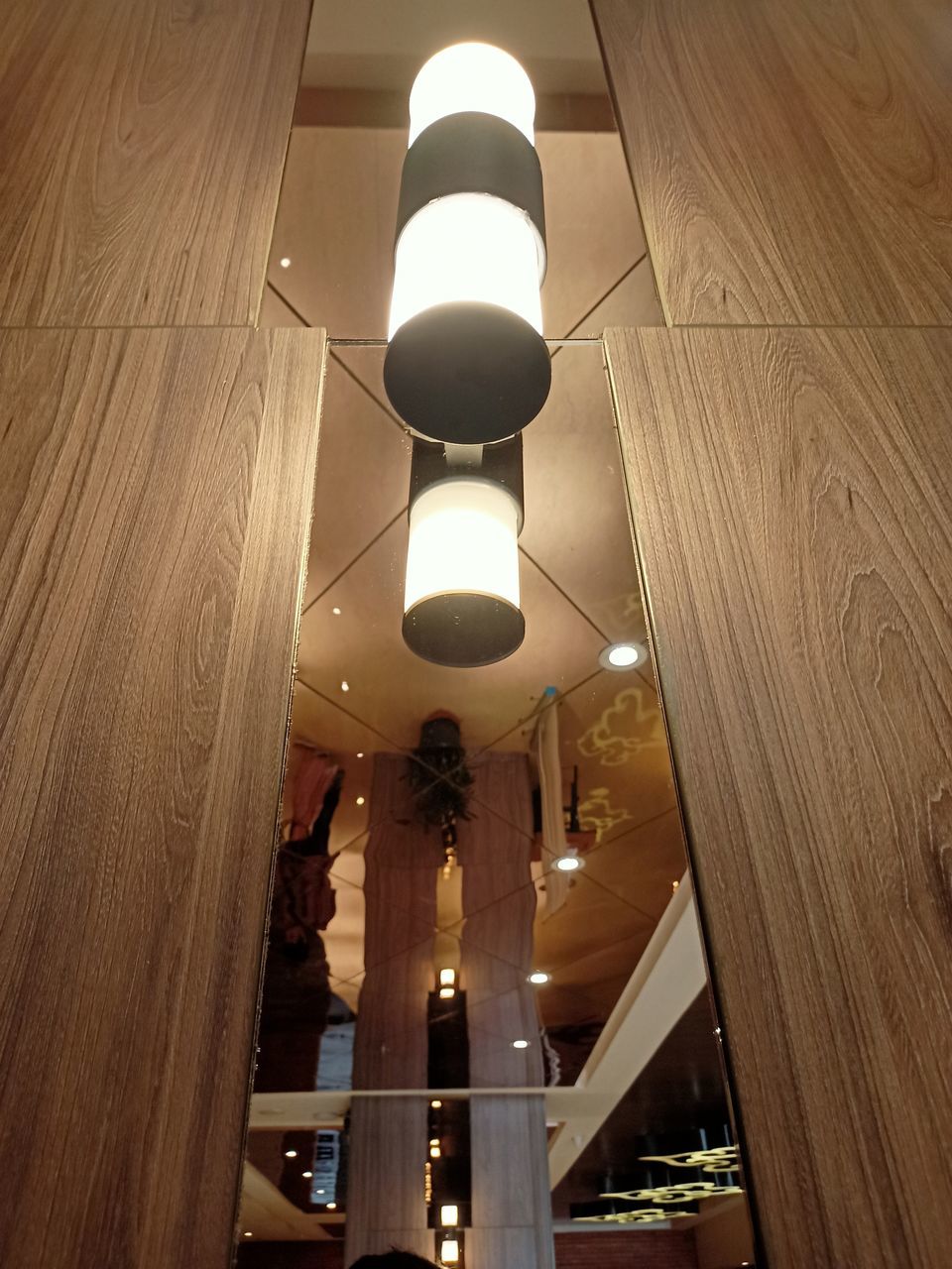 LOW ANGLE VIEW OF ILLUMINATED PENDANT LIGHT AT HOME