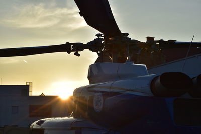 Close-up of airplane against sky during sunset