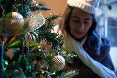 Portrait of woman with christmas tree