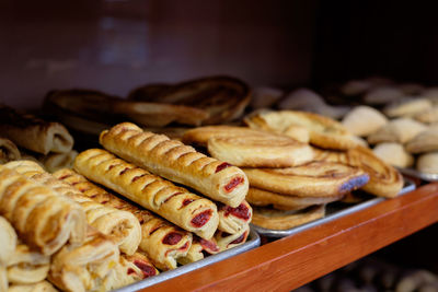 Close-up of baked pastry items for sale in bakery