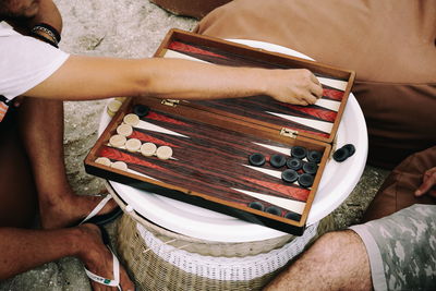 High angle view of men playing backgammon at beach