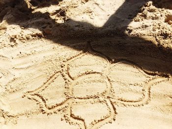 High angle view of shadow on sand