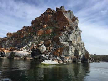 Rock formations in sea against sky