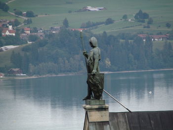 Statue on mountain against sky