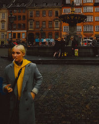 Woman standing on street in city