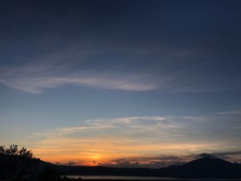 Scenic view of silhouette mountains against sky at sunset