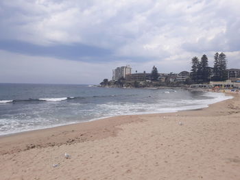 Scenic view of beach against sky in city