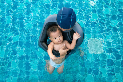 High angle view of boy swimming in pool