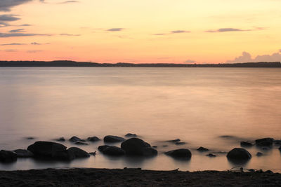 Scenic view of sea against sky at sunset